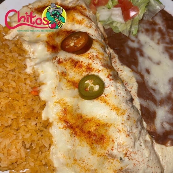 Chitos Mexican Restaurant's enchilada with white sauce, rice, refried beans, and jalapeños.