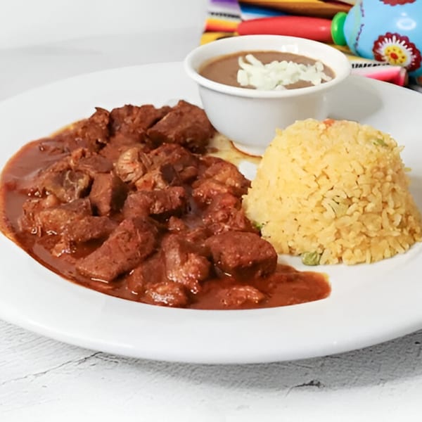 Chito's Authentic Mexican Restaurant's carne guisada with rice and a side of refried beans.
